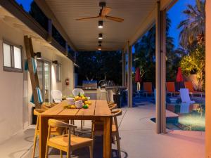 Una mesa y sillas de madera en un patio. en Fab Four at El Mirador by ACME House Company, en Palm Springs