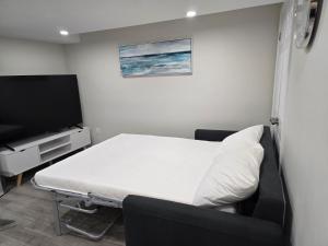 a hospital room with a bed and a flat screen tv at Charming Suite in Cambridge