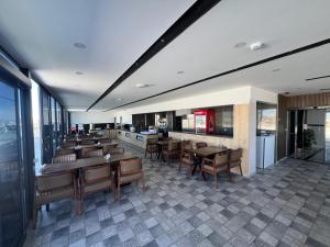 a restaurant with tables and chairs in a room at Milena Otel in Midyat