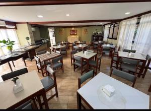 a restaurant with tables and chairs in a room at Recanto da Orla in Aracaju