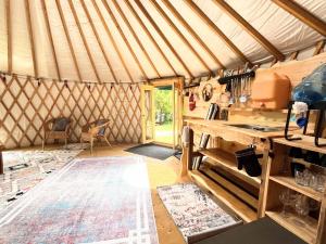 a room with a yurt with a table and a counter at Sky Nest Glamp-Unplug-Reconnect in Red Bay