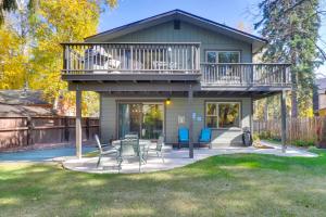 a house with a balcony and a table and chairs at 5 Mi to Whitefish Resort Minutes to Chairlifts! in Whitefish