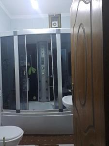 a bathroom with a toilet and a sink and a mirror at شقة مميزة in Rujm Maghghijhah +7 photos