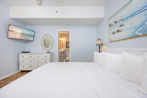 a white bedroom with a large bed with white pillows at Phoenix I 1144 condo in Orange Beach +44 photos