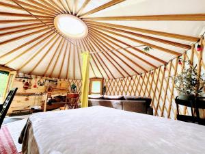 a bedroom with a large bed in a yurt at Star-Lake Yurt Sanctuary Waterview in Red Bay