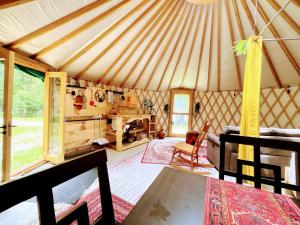 a yurt living room with a table and chairs at Star-Lake Yurt Sanctuary Waterview in Red Bay