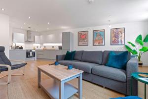 a living room with a couch and a table at 2 Bed Modern Apartment in City Centre Birmingham in Birmingham