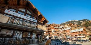 a group of buildings in a mountain town at Résidence Le Centre - 2 Pièces pour 5 Personnes MAE-3332 in Champagny-en-Vanoise +17 photos