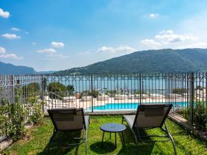 two chairs and a table in front of a pool at La Bella Riva in Sarnico