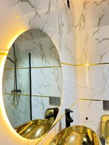 a bathroom with two sinks and a mirror at Austra hotels and suite Maitama Abuja in Abuja