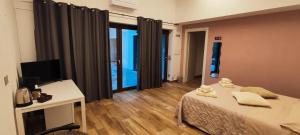 a bedroom with a bed and a desk and a television at Antica Fontana in Bernezzo