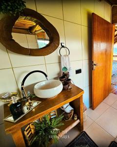 a bathroom with a sink and a mirror at Cabana Araucária in Bom Retiro