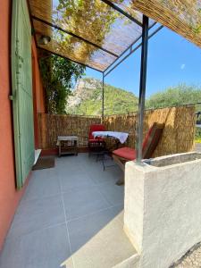 a patio with a table and chairs and a fence at STUDIO pied village EZE - dans VILLA - Parking Gratuit in Èze