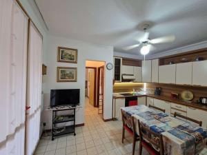 a kitchen with a table and a tv in it at Pomposa 41 in Lido di Pomposa