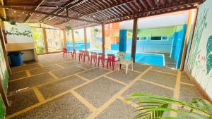 a patio with chairs and a swimming pool at Bungalows El Rincon de La Riviera in Rincon de Guayabitos