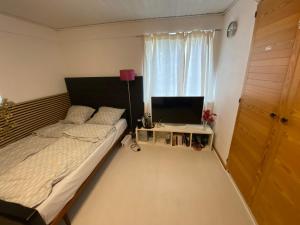 a bedroom with a bed and a desk with a laptop at Family room in centrum 300m to Lego House and walking street in Billund