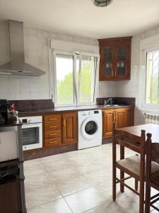 a kitchen with a washing machine and a dishwasher at 3Raigaños Vivienda Vacacional in Sales +6 photos