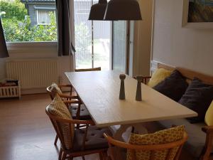 a living room with a wooden table and chairs at 4 star holiday home in Olofström-By Traum in Olofström +21 photos
