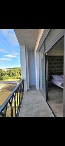 a balcony of a house with a bed and a balcony at Alvina SJS in Tsaghkadzor