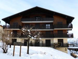 a large building with a balcony in the snow at Résidence Le Royal - Royal 16 MAE-5321 in Combloux