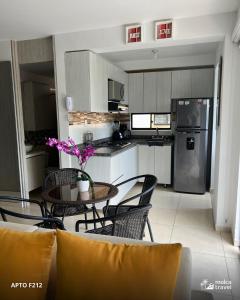 a kitchen with a table and chairs and a refrigerator at Alojamiento Familiar Premium - Con Piscinas, Jacuzzi y Capacidad 13 - By Molca Travel in Armenia