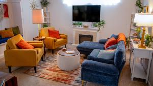 a living room with couches and chairs and a tv at The Spacious Surprise in Hastings