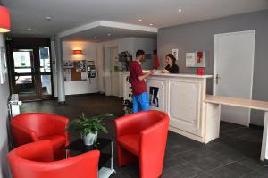 a man and a woman standing at a counter at Résidence Les Pleiades - Appartement spacieux et lumineux · Centre station · Balcon · Parking couvert MAE-7354 in Flaine