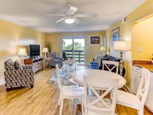 a living room with a table and chairs at Our Cooler Getaway in Tybee Island