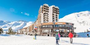 a large building on a ski slope in the snow at Résidence Palafour - Studio 4 rénové, confort moderne - balcon vue lac MAE-8175 in Tignes