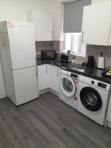 a kitchen with a washing machine and a refrigerator at Lyndon house in Beaufort