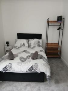 a bedroom with a bed with a black and white comforter at Lyndon house in Beaufort