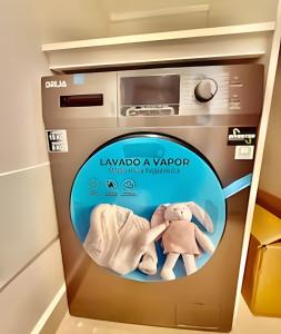 a poster of a oven with two stuffed animals in it at Garden Breeze 1 By Advantage Club in La Laguna +8 photos