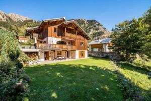 a large house with a large yard in the mountains at Chalet Alpaga - Chalets pour 12 Personnes MAE-7864 in Champagny-en-Vanoise