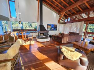 a living room with a couch and a table at Refúgio das Nuvens | by The Lodges in Campos do Jordão