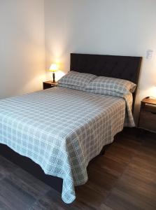 a bedroom with a bed with a blanket on it at Portezuelo de árboles in Panaholma