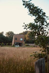 a barn in the middle of a field at Zen Sasino in Sasino
