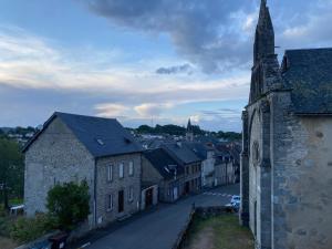 a view of a town with a church and buildings at Appartement centre ville in Ussel