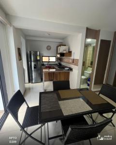 a dining room table and chairs in a kitchen at Gran Alojamiento Familiar con 4 Piscinas y Jacuzzi - Para 13 personas - By Molca Travel in Armenia +12 photos