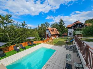 an image of a backyard with a swimming pool and a house at Apartments Andrić in Kaludjerske Bare
