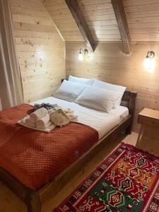 a bedroom with a bed in a wooden room at Arhetip, Kikina Villa in Njegovuđa