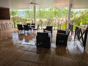 a dining room with chairs and a table with a view at La Casa de la Montaña in El Picacho