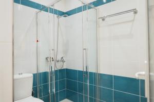 a bathroom with a shower and a toilet at Hotel Blue Sky in Sarandë