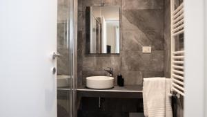 a bathroom with a sink and a mirror at Suites 215 Colosseum - Guesthouse in Rome