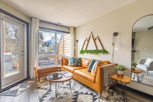 a living room with a couch and a table at Alpine Oasis at Alpine Village in Canmore +67 photos