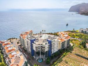 an aerial view of a building next to the ocean at Doca's Refuge by Homie in Ilhéu do Gorgulho