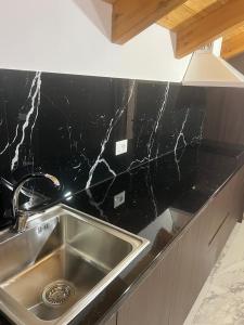 a kitchen with a sink and a counter top at Guest house Andersoni Dhoma plazhi Andersoni in (( Shën Ded Gjoni )) +20 photos