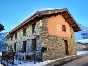 a stone building with a black fence in front of it at Chalet Barthelemy - Petit cocon authentique dans les 3 vallées MAE-4204 in Saint-Martin-de-Belleville +3 photos