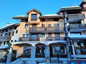 a tall building with balconies on the side of it at Résidence Biolley 1 - Studio pour 2 personnes dans le centre du village MAE-4274 in Saint-Martin-de-Belleville +3 photos