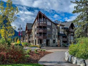 a large apartment building in the mountains at Creekside at Rundle Cliffs Lodge in Canmore