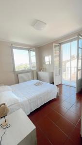 una camera con letto bianco e pavimento piastrellato di Ampio appartamento centro storico a Montalto Pavese Altre 22 foto